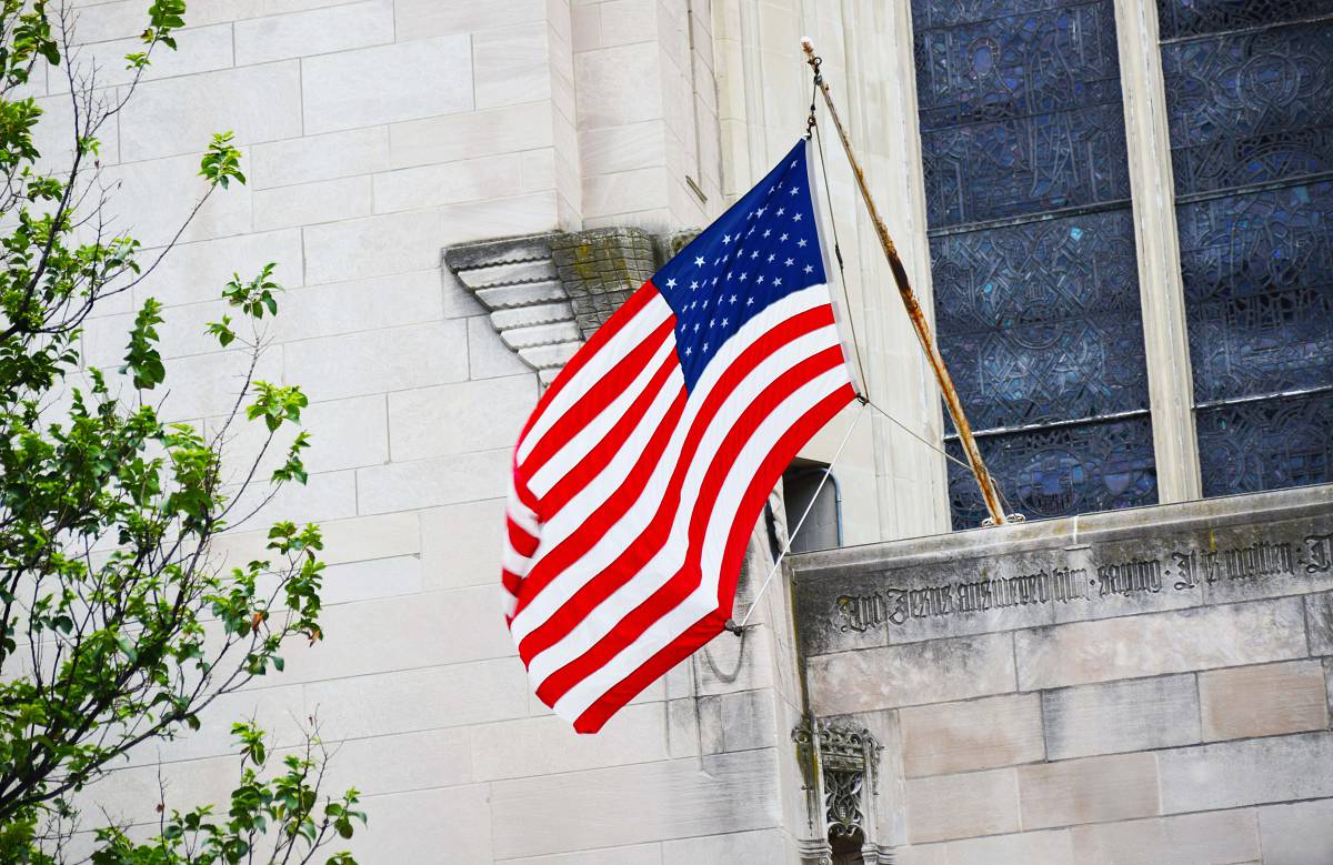 united states flag of USA mounted on building new york